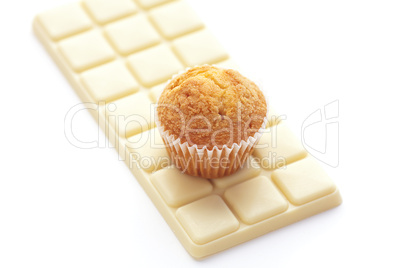 bar of white chocolate and muffin isolated on white