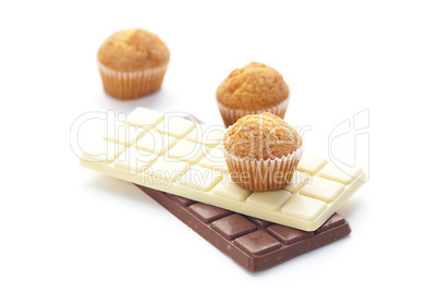 bar of chocolate and muffin isolated on white