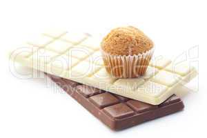 bar of chocolate and muffin isolated on white