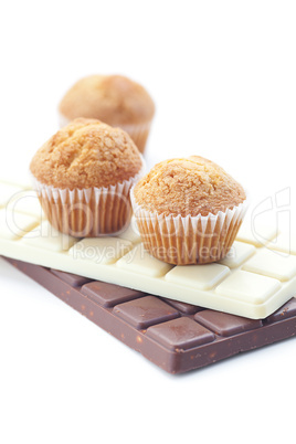 bar of chocolate and muffin isolated on white