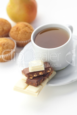bar of chocolate,tea and muffin isolated on white