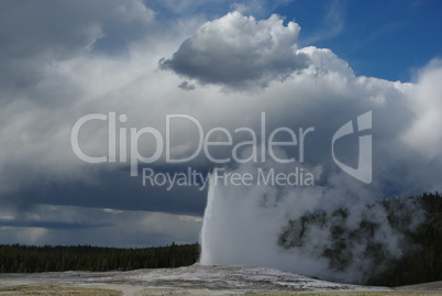 Old Faithful Geysir merging with clouds, Yellowstone National Park, Wyoming