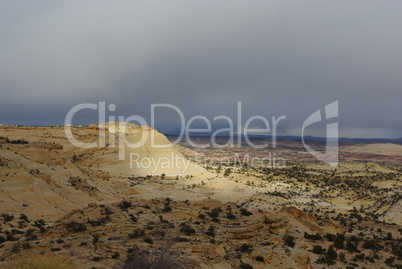 Soft light of sun through clouds on rock hills, Grand Stair Escalante National Monument, Utah