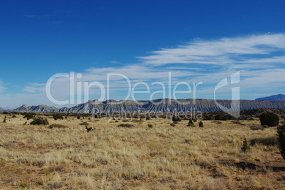 High desert, sandstone hills, blue and white sky, Utah