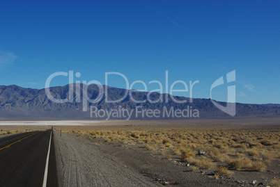 Highway to salt flats and high mountain chain, Nevada desert