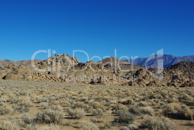 Alabama Hills and Inyo Mountains under blue sky, California