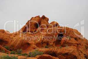 Orange rock under grey sky, Nevada