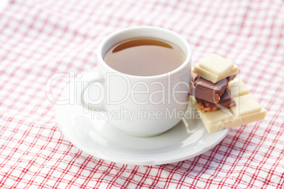 bar of chocolate and tea on plaid fabric