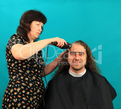 Man having an haircut on the green background