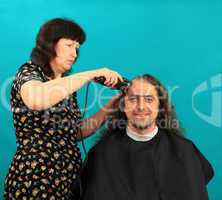 Man having an haircut on the green background