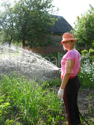 The girl watering a kitchen garden