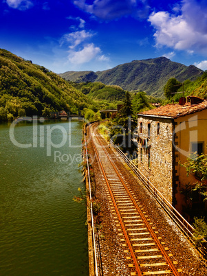 Railway with River, Sky and Vegetation in Tuscany