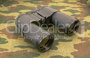 Binocular on a camouflaged background