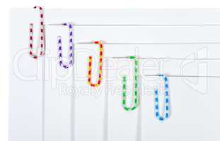 White sheets of paper with colourful paper clips