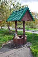 Countryside water well with a bucket.