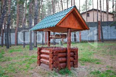 Countryside water well with a bucket.