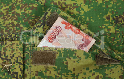 Banknotes in the military uniform pocket