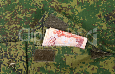 Banknotes in the military uniform pocket