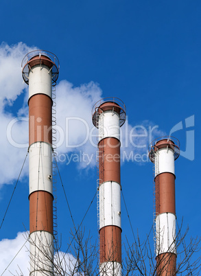 Lots of smoking chimneys other blue sky