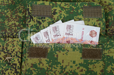 Banknotes in the military uniform pocket