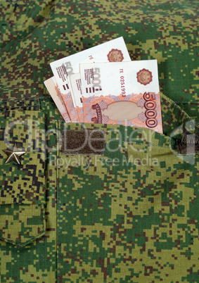 Banknotes in the military uniform pocket