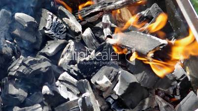 grill with charcoal and flames
