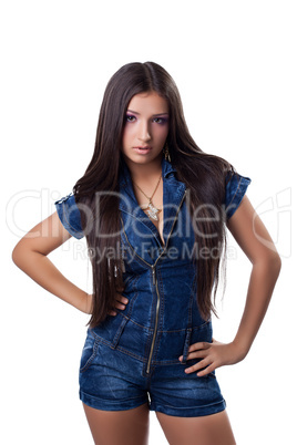 Brunette young woman in jeans overalls