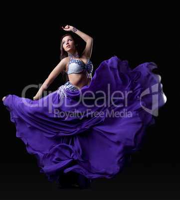 Young woman dancing oriental dance