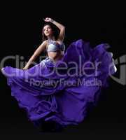 Young woman dancing oriental dance
