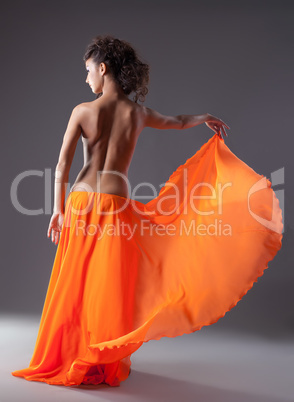 woman dance in orange veil with naked spine