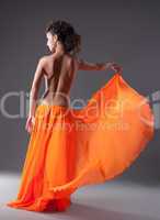 woman dance in orange veil with naked spine