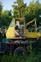 Blonde young woman sitting in tractor