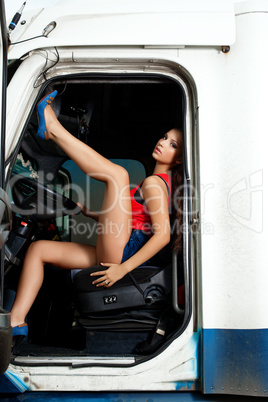 sexy young woman posing in truck cabin