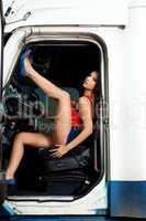 sexy young woman posing in truck cabin