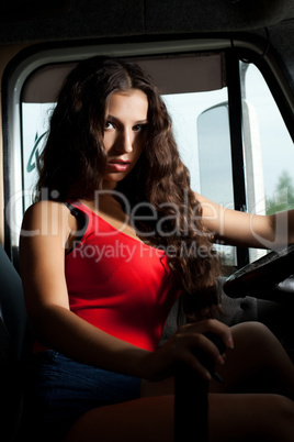 Sexy brunette woman sitting in car