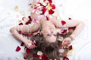Young woman in rose petals