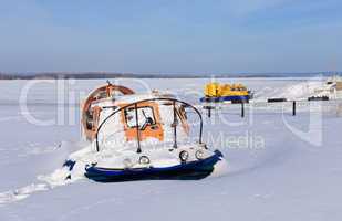Hovercraft on the bank of a frozen river