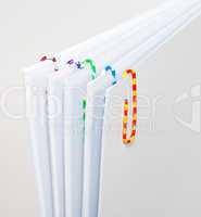 White sheets of paper with colorful paper clips