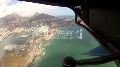 Helicopter Flying over Harbor and Cape Town