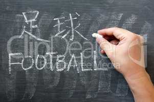 Football - word written on a blackboard with a Chinese version