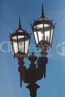 two old lanterns against the blue sky