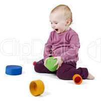 young child playing with colorful toy blocks