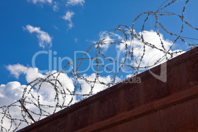 Barbed wire on a background of blue sky.