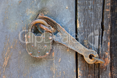 Old padlock on a wooden door