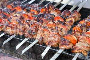 Juicy slices of meat with sauce prepare on fire (shish kebab)