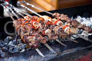 Juicy slices of meat with sauce prepare on fire (shish kebab).