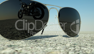 glasses lying on the   asphalt  with the reflection of  the motorcycle  deformed by the heat