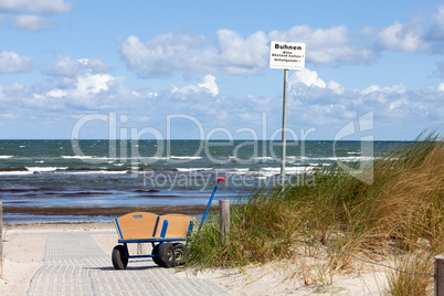 Bollerwagen steht allein am Wegesrand zum Strand