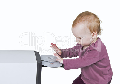 young child playing with CD