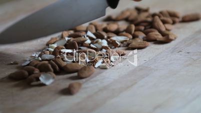 Hand of a woman chopping almonds